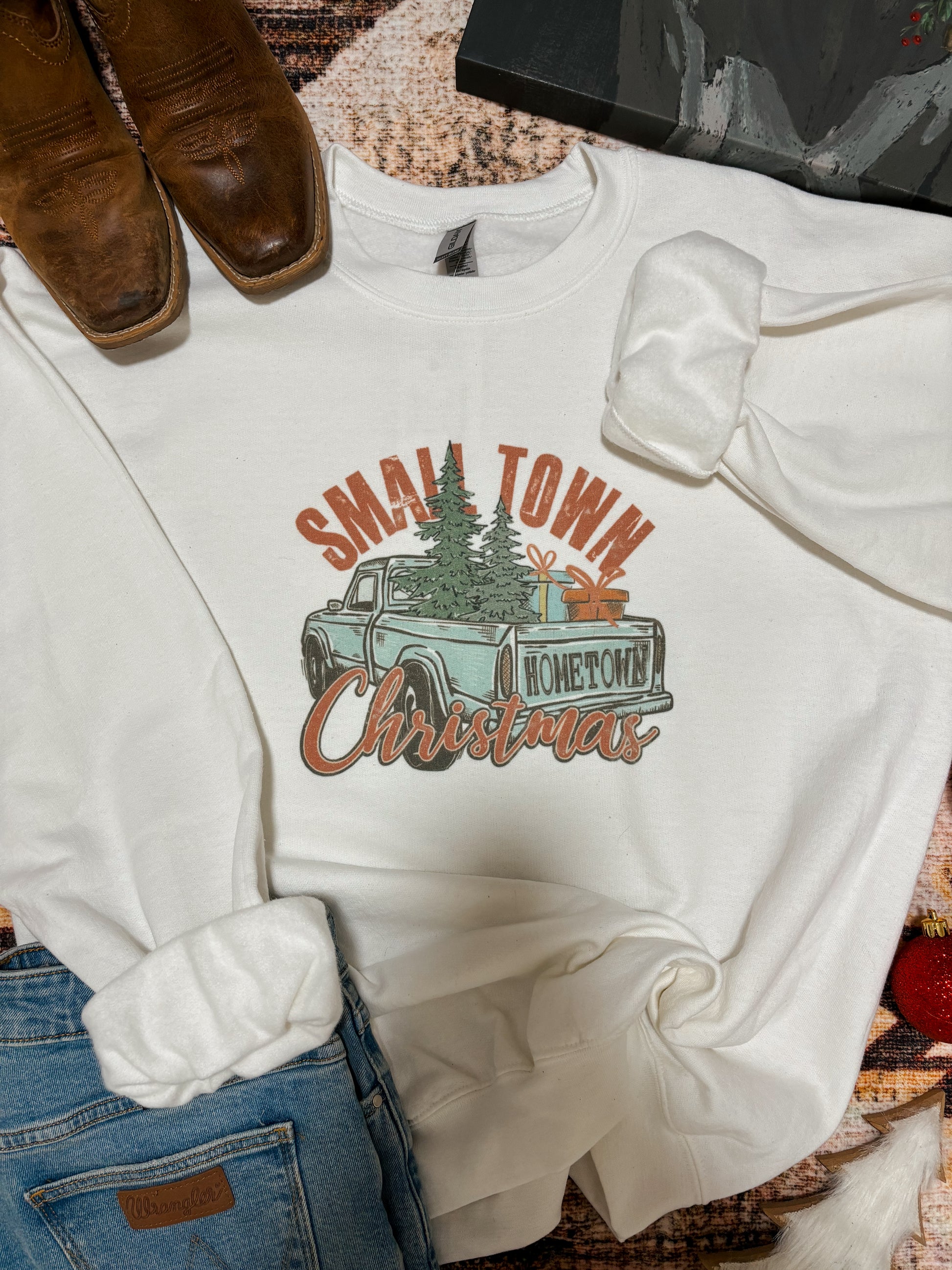 Close-up of the Small Town Christmas crewneck showcasing retro holiday truck and script text.