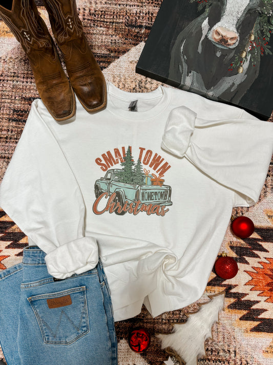 Flat lay of the Small Town Christmas crewneck with vintage truck design, styled with jeans and boots