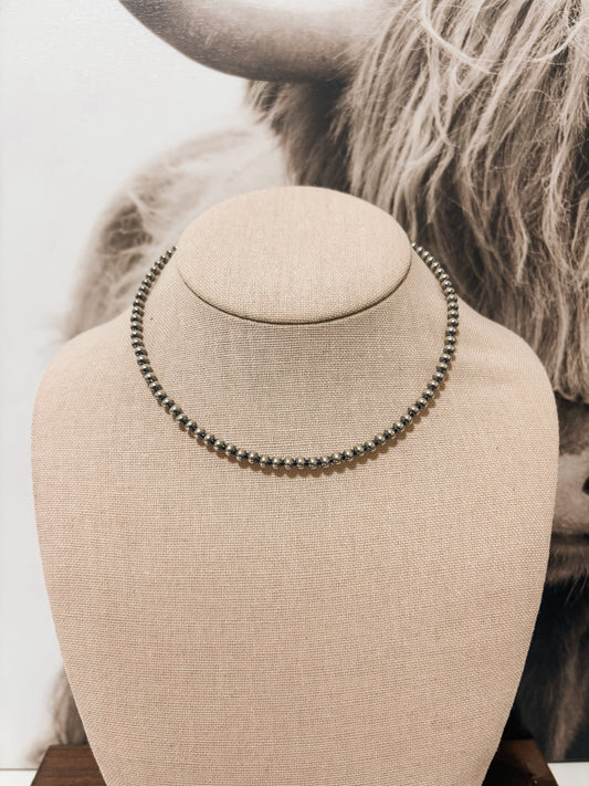 Front view of 4mm 14-inch sterling silver pearl necklace on beige jewelry bust