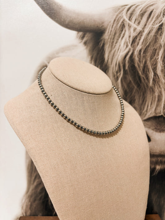 Side angle of sterling silver pearl choker necklace with 4mm beads