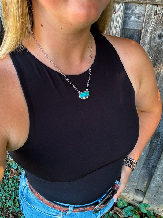 Model wearing the Stillwater Bar Necklace styled with black tank and jeans