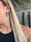 Close-up of model wearing Turquoise Canyon Dangle Earrings with vivid turquoise stones and silver rope detailing.