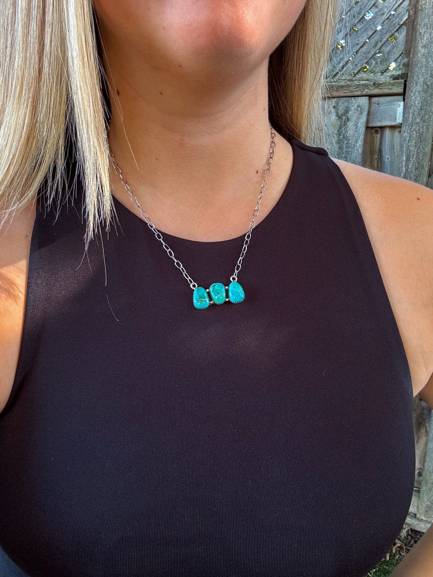 Close up of the Turquoise Wildstone Necklace featuring three stacked turquoise stones on a silver chain.
