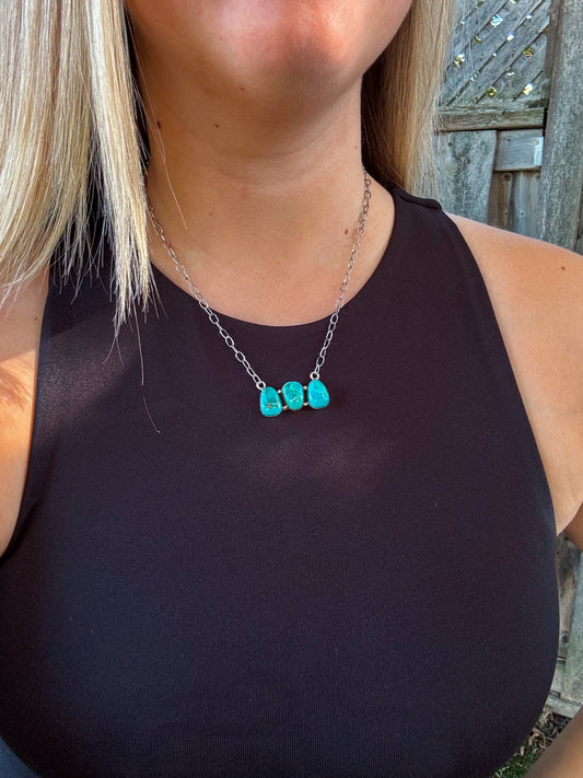 Close up of the Turquoise Wildstone Necklace featuring three stacked turquoise stones on a silver chain.