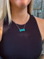 Close up of the Turquoise Wildstone Necklace featuring three stacked turquoise stones on a silver chain.