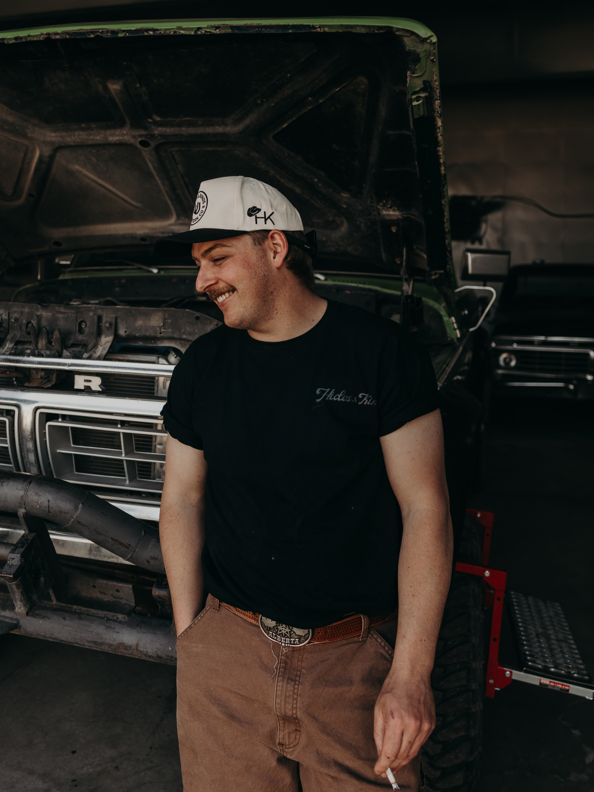 Model wearing the Hides & Kinds Big Buck Tee featuring the front logo and relaxed fit.