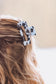Black cow print claw clip styled in wavy blonde hair – western-inspired accessory