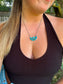 Styled image of the Bluebell Cluster Necklace worn with a black tank top, showcasing its dainty and feminine western design.