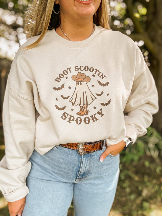 Close up of Boot Scootin' Spooky Halloween sweatshirt featuring western ghost graphic and fall vibes.