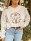Close up of Boot Scootin' Spooky Halloween sweatshirt featuring western ghost graphic and fall vibes.