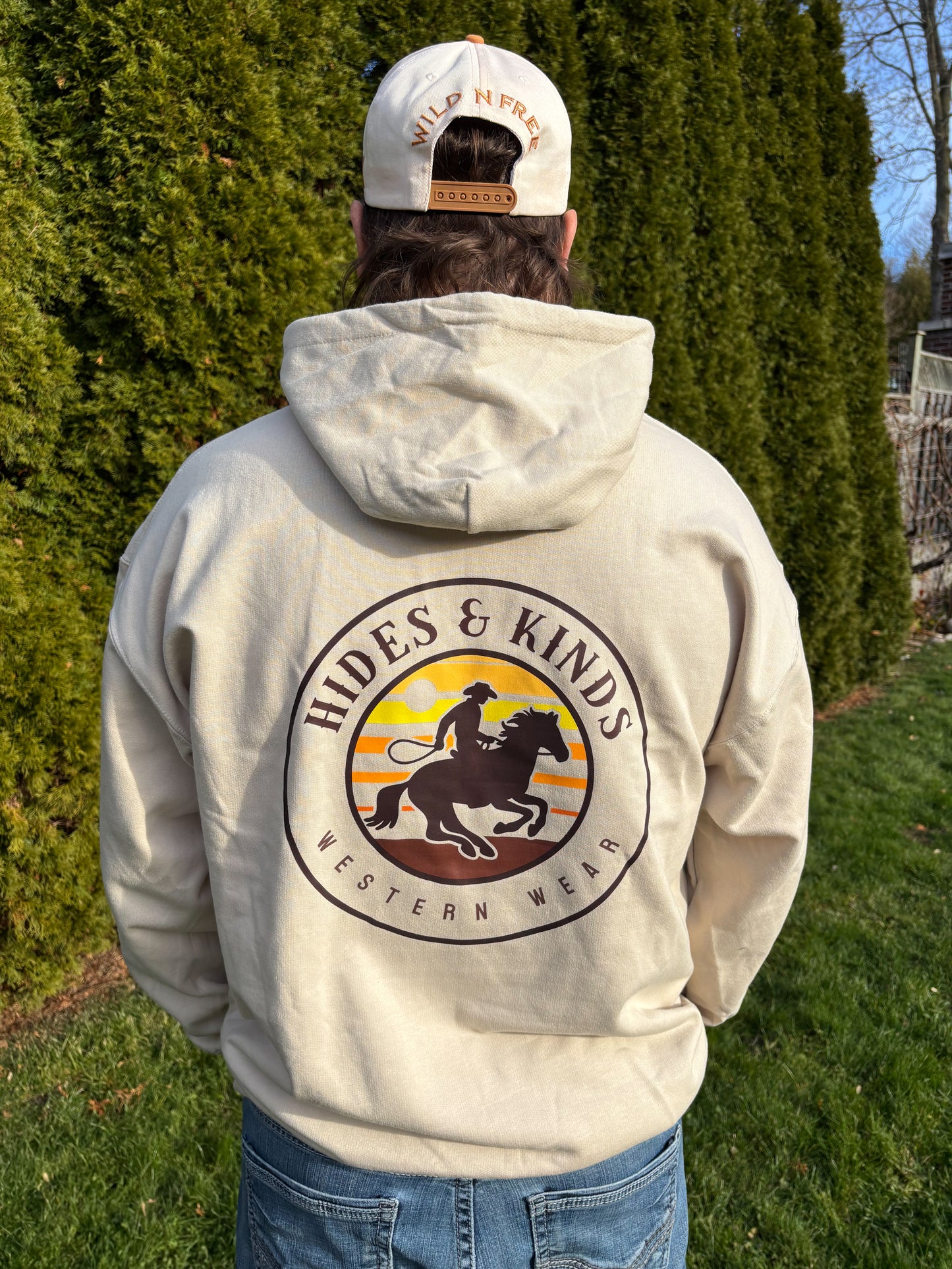 Back view of sand Broke Bronc hoodie featuring Hides & Kinds western wear bronc rider graphic