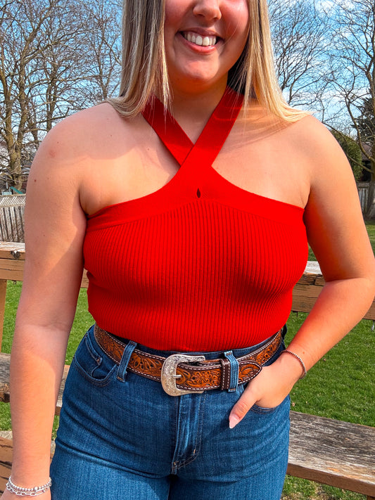Model wearing Callie Cross Neck Crop Top in red with tooled western belt