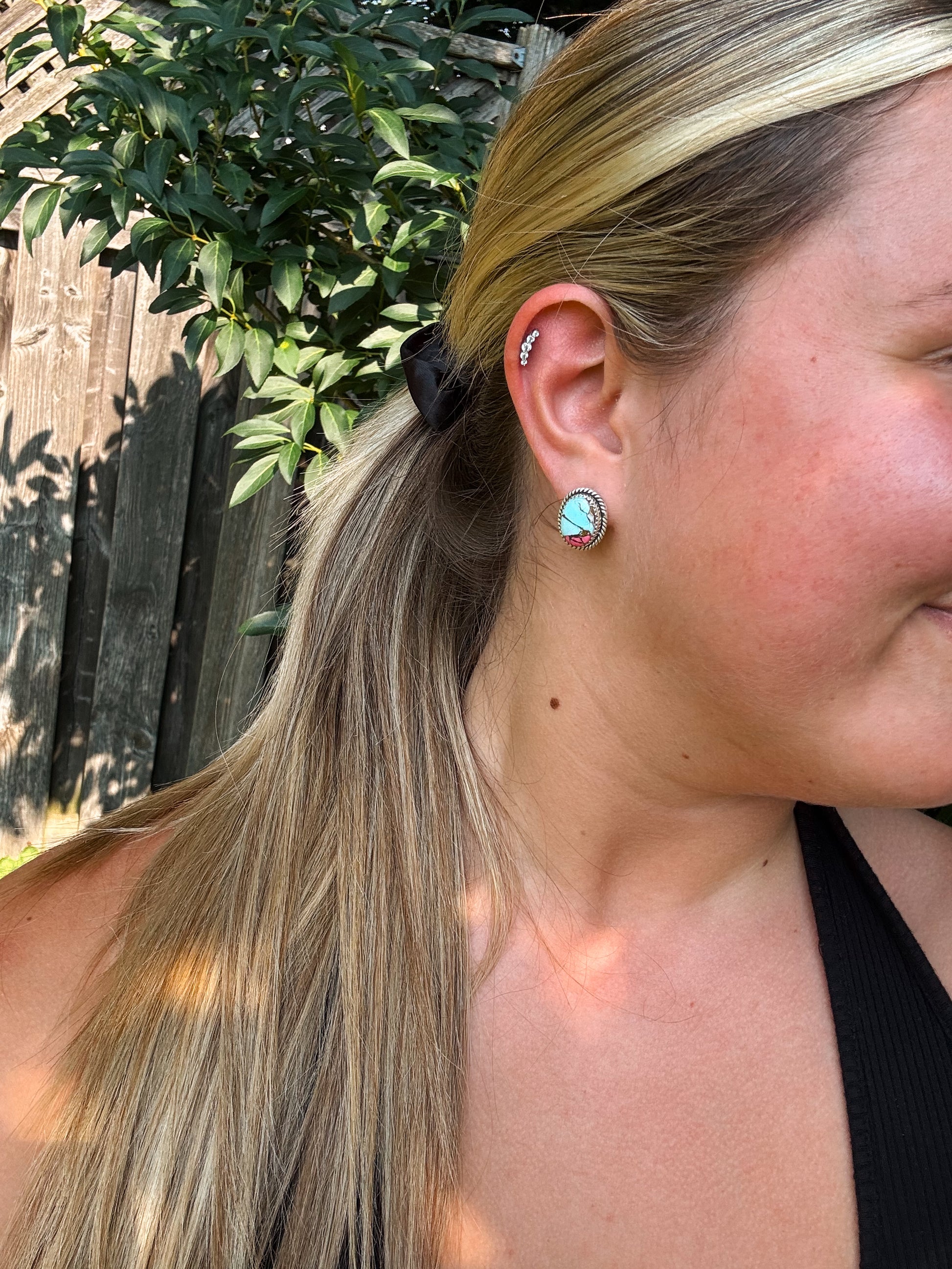Model wearing Candy Quartz Stud Earrings outdoors, showing pink and turquoise stone detail