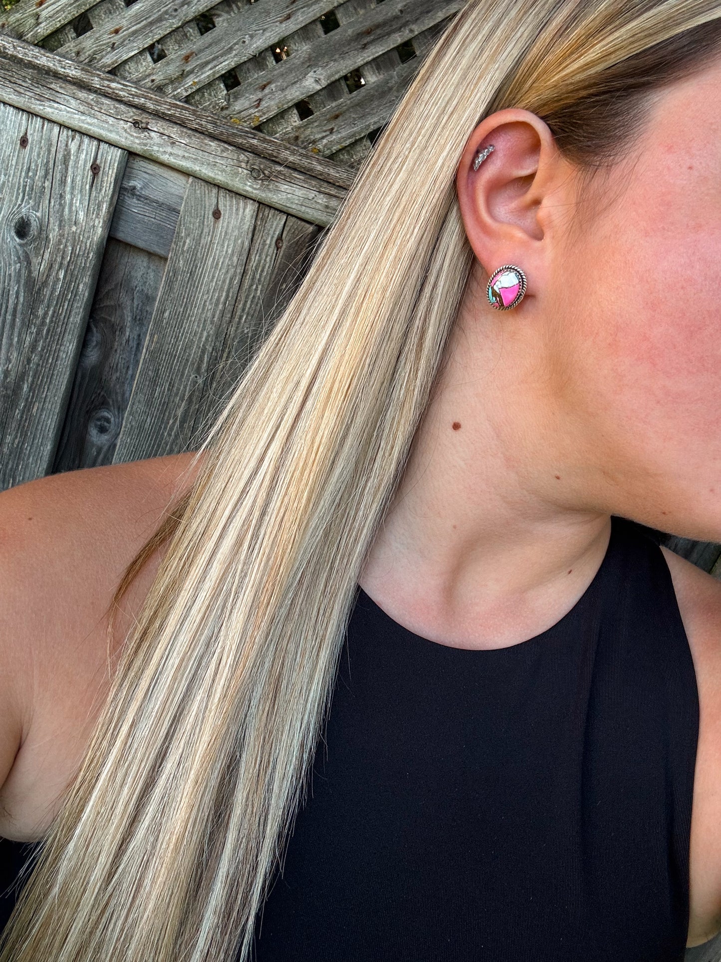 Candy Quartz Studs with bold pink and green tones displayed on ear, silver setting visible against straight blonde hair.
