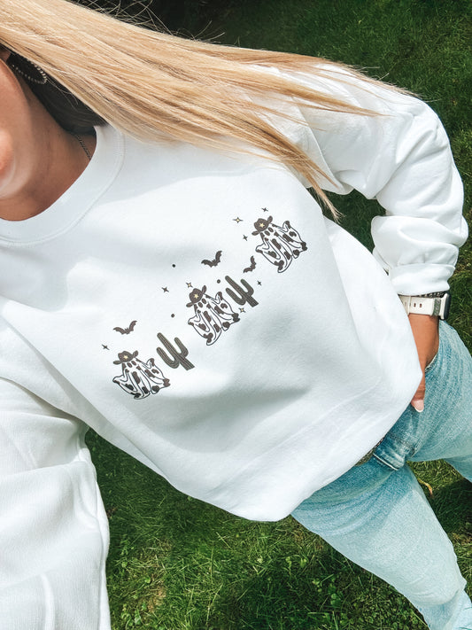 Western Halloween crewneck with cow print ghosts and cactus icons – laid-back fall fashion from Hides and Kinds