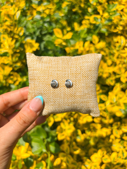 Sterling silver cowboy hat stud earrings on burlap display