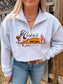 Full shot of model in Hides and Kinds Desert Horse Quarter Zip, paired with jeans and a western belt, standing by a rustic fence.