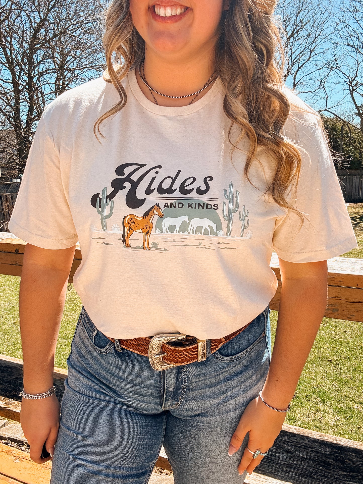 Focused view of the Hides and Kinds horse design with desert scene on the natural colored tee