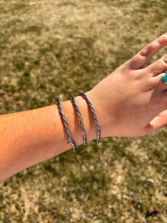 Western style double rope cuff bracelet close-up with detailed silver twist design