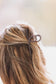 Model wearing Down South Pearl Claw Clip securing hair in western style – Hides & Kinds