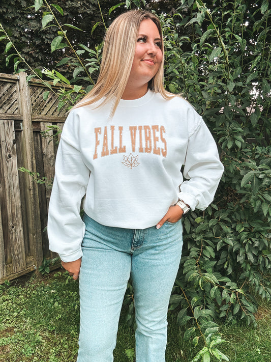 Full body photo of woman in Fall Vibes crewneck and denim, fall ready country outfit.