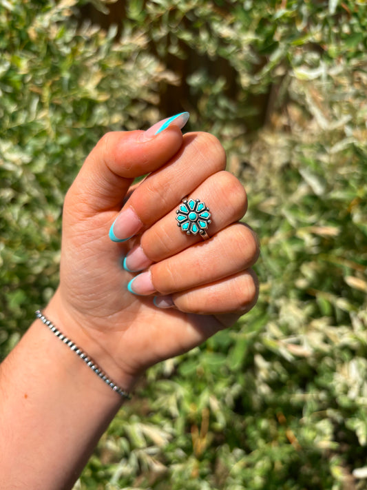 Close-up of turquoise flower ring – handmade sterling silver jewelry by Hides & Kinds