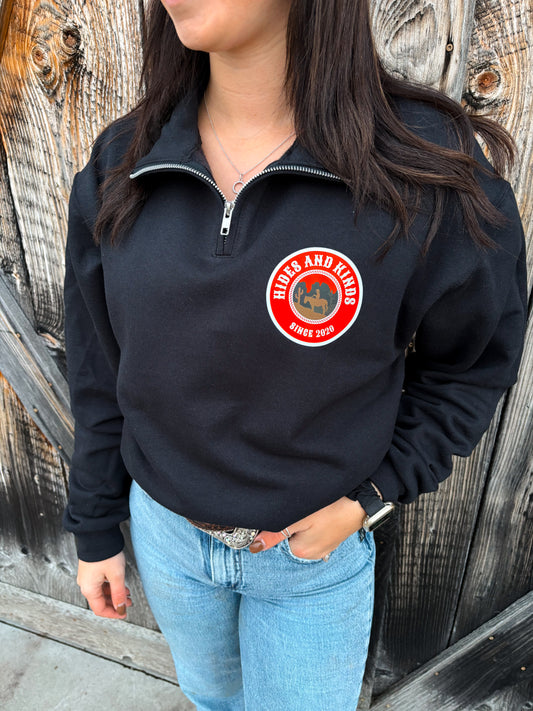Front view of the Heritage Ranch Quarter Zip in black with the retro HK ranch badge logo.