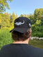 Back view of Hides & Kinds black meshback trucker hat with white embroidered longhorn logo