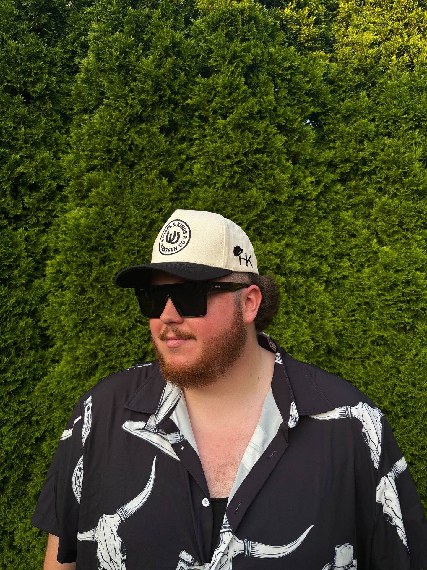 Man wearing The Outrider Hat showing front logo and side HK branding