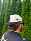  Side profile of man in The Outrider Hat featuring cowboy hat + HK logo.