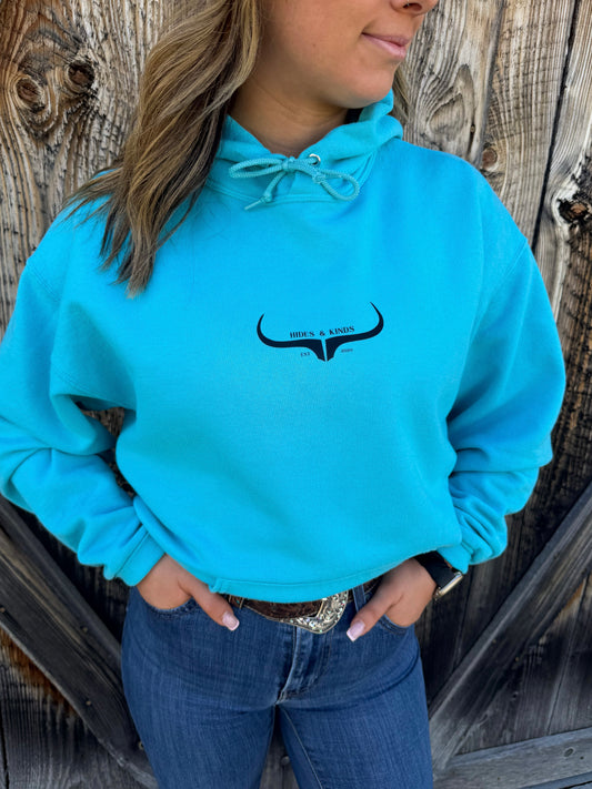 Teal western hoodie with small longhorn logo on front by Hides and Kinds
