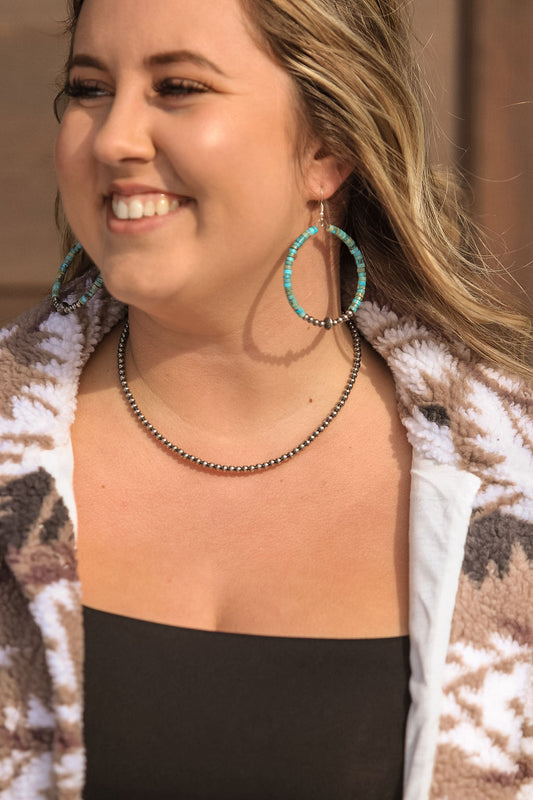 Side view of turquoise and silver hoop earrings with sterling silver saucer pearls – handcrafted western jewelry