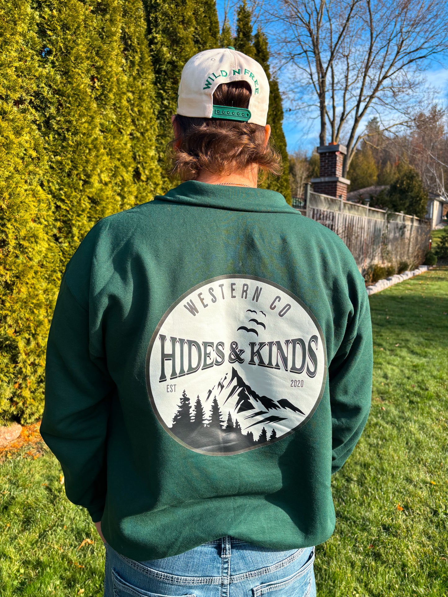 Back view of forest green High Country quarter zip featuring large Hides & Kinds mountain graphic