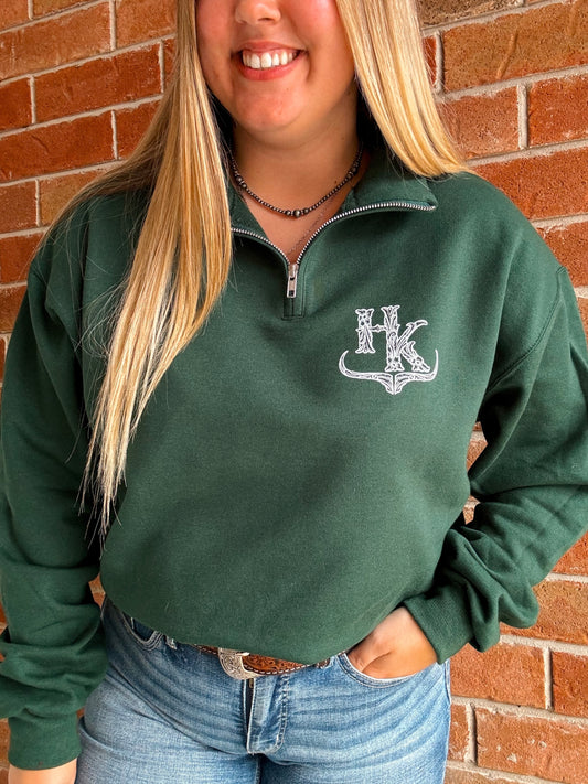 HK Branded forest green quarter zip styled with jeans, featuring detailed bullhorn chest design.