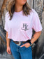 Close up of the HK Branded Pocket Tee in Blossom Pink featuring the original western style HK logo printed on the front pocket.