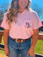 Modeled image of the Blossom Pink branded pocket tee styled with denim jeans and western accessories, highlighting the logo placement.