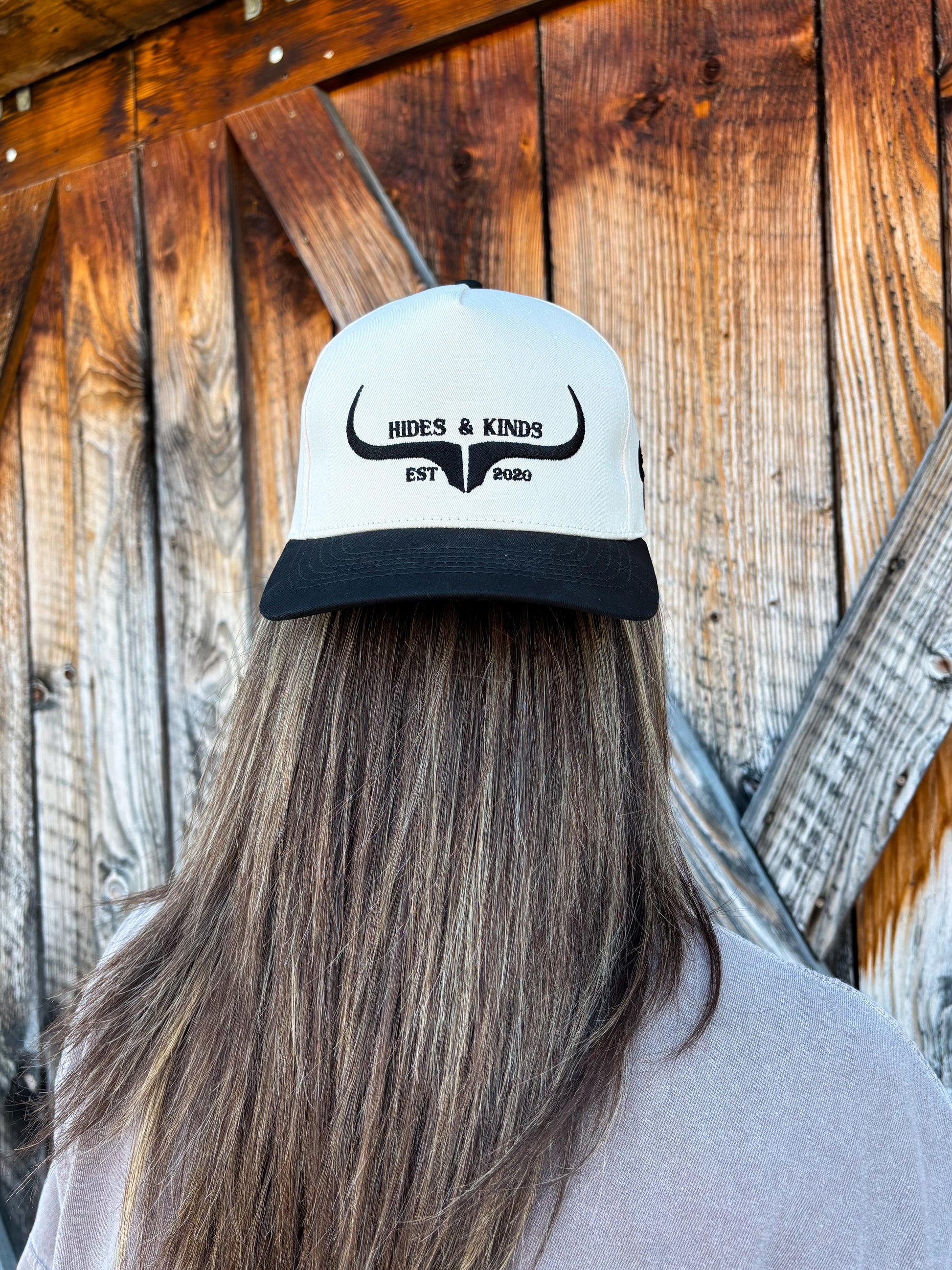 Back view of the Hides & Kinds original logo hat in black and natural, showing embroidered western longhorn logo and structured fit.