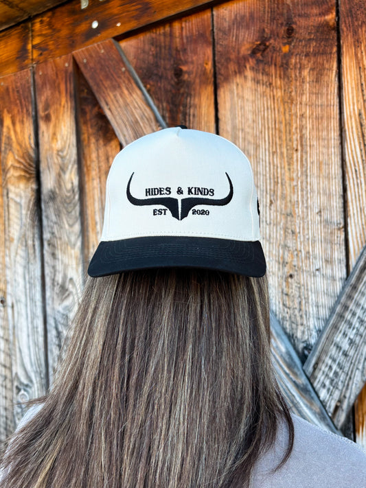 Back view of the Hides & Kinds original logo hat in black and natural, showing embroidered western longhorn logo and structured fit.