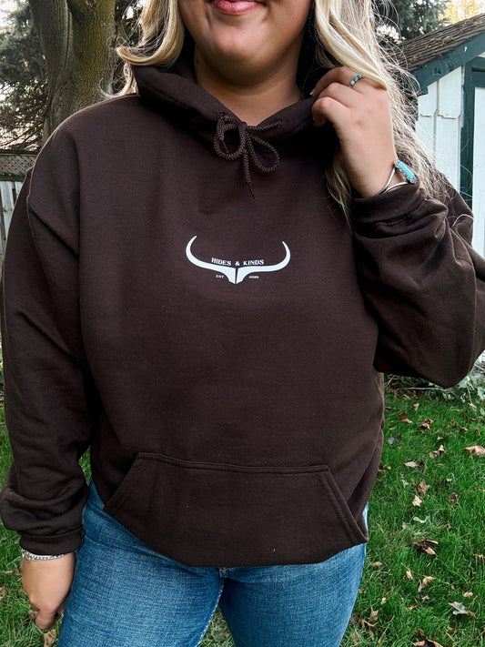 Close up view of the HK Original Logo Hoodie in chocolate brown, showing the white longhorn graphic and front pocket detail.