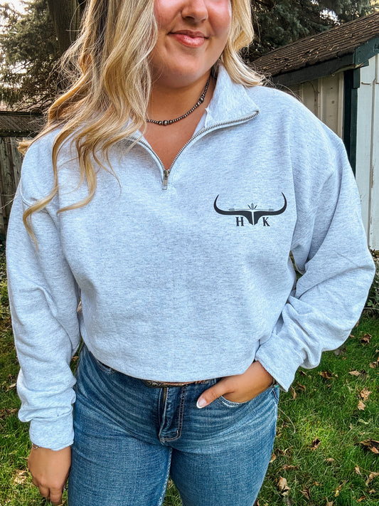 Close up of HK Quarter Zip in Ash Grey featuring embroidered HK design on left chest