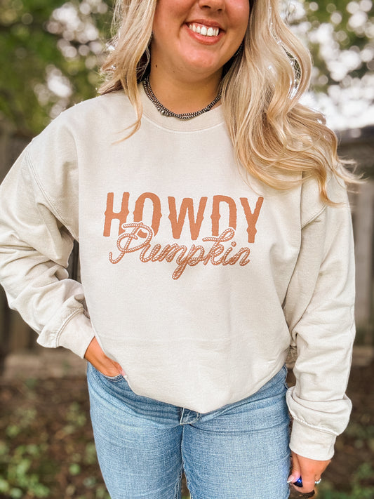 Woman wearing the Howdy Pumpkin crewneck in a close up front view with western rope font design.