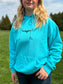 Front view of a teal western hoodie with Hides and Kinds longhorn logo – Hides and Kinds