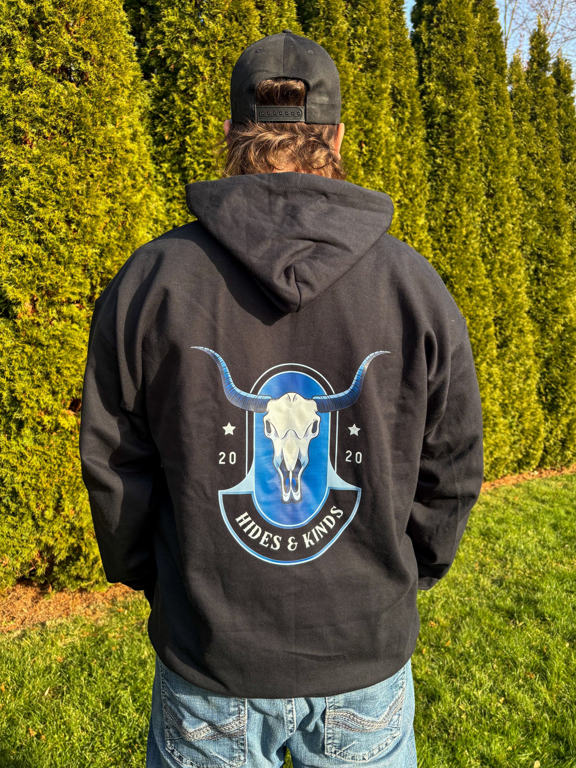 Back view of black Midnight Longhorn hoodie featuring blue longhorn skull graphic