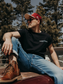 Model wearing the Hides & Kinds North Country Tee featuring the front logo and relaxed fit while outdoors.