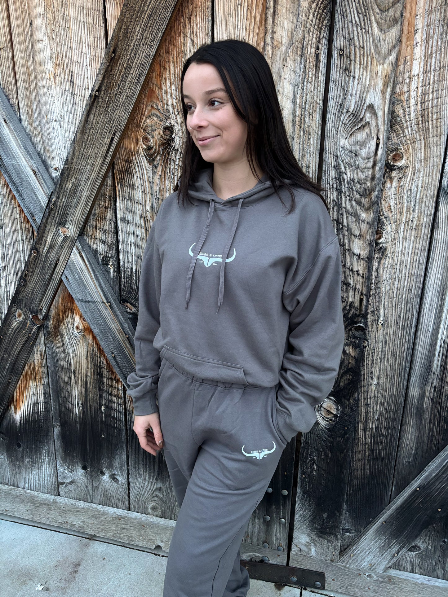 Front view of the Original Logo Matching Set in charcoal grey featuring the HK longhorn logo on the hoodie and joggers.