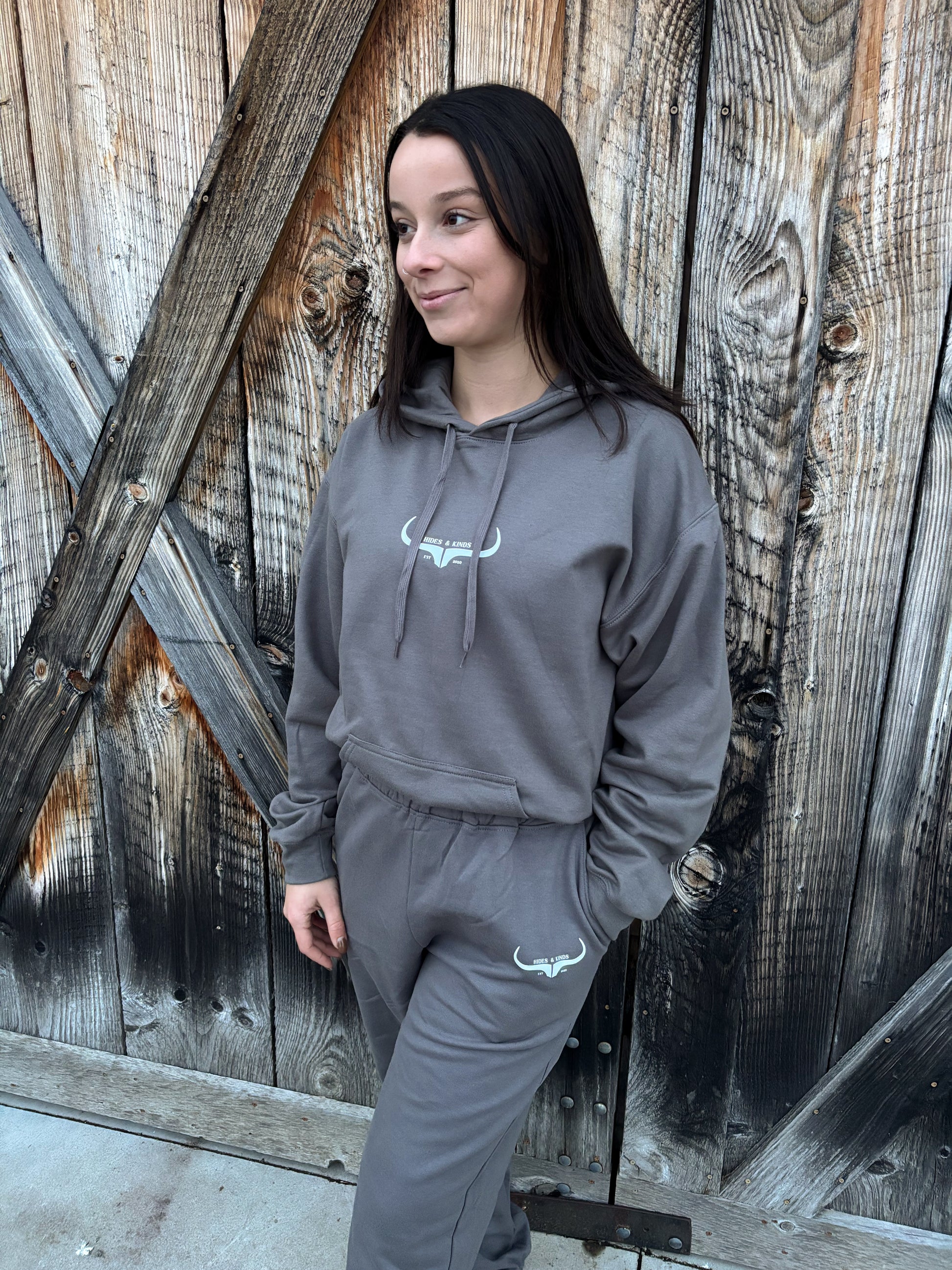 Front view of the Original Logo Matching Set in charcoal grey featuring the HK longhorn logo on the hoodie and joggers.