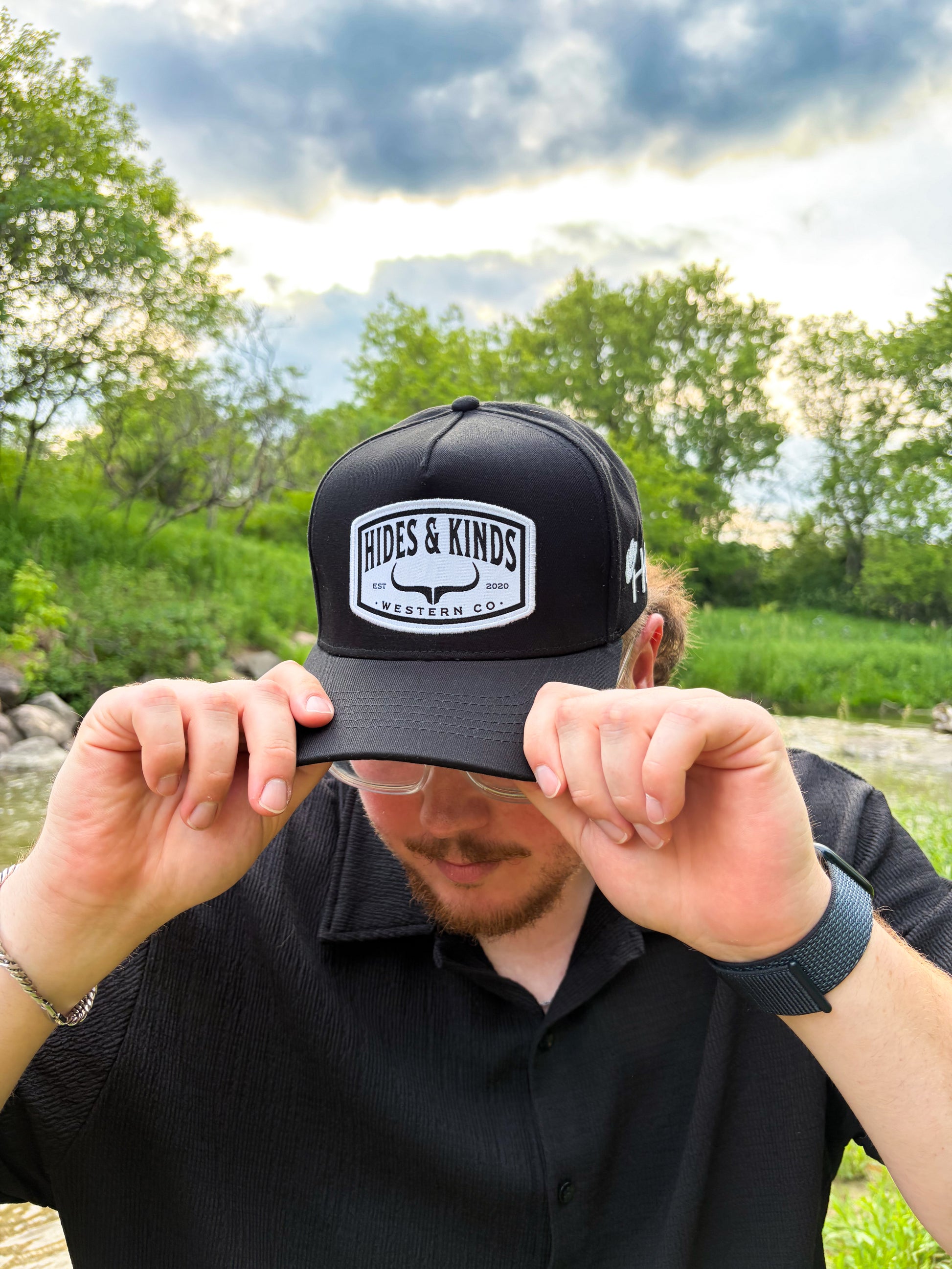 Angled view of the Hides & Kinds Outlaw Hat highlighting the Western Co. patch and embroidered HK side logo.