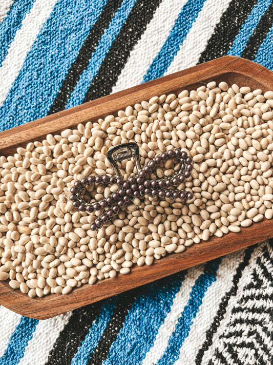 Pearl Bow Clip displayed on cream beans with western blanket background – Hides & Kinds
