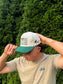 Side view of The Ranchline Hat on a man, capturing the side logo and curved brim.