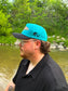 Side view of the Hides & Kinds Retro Country Hat showing the embroidered HK logo and structured snapback fit.